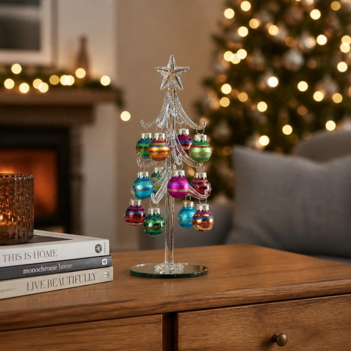 Glass Christmas tree ornament with coloured baubles on a sideboard - APA Pure Living