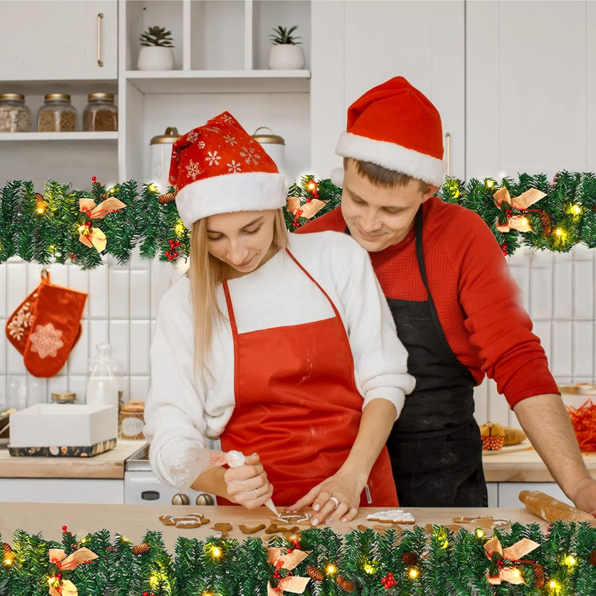 Pre-lit Christmas garland lighting a kitchen while a couple decorate gingerbread