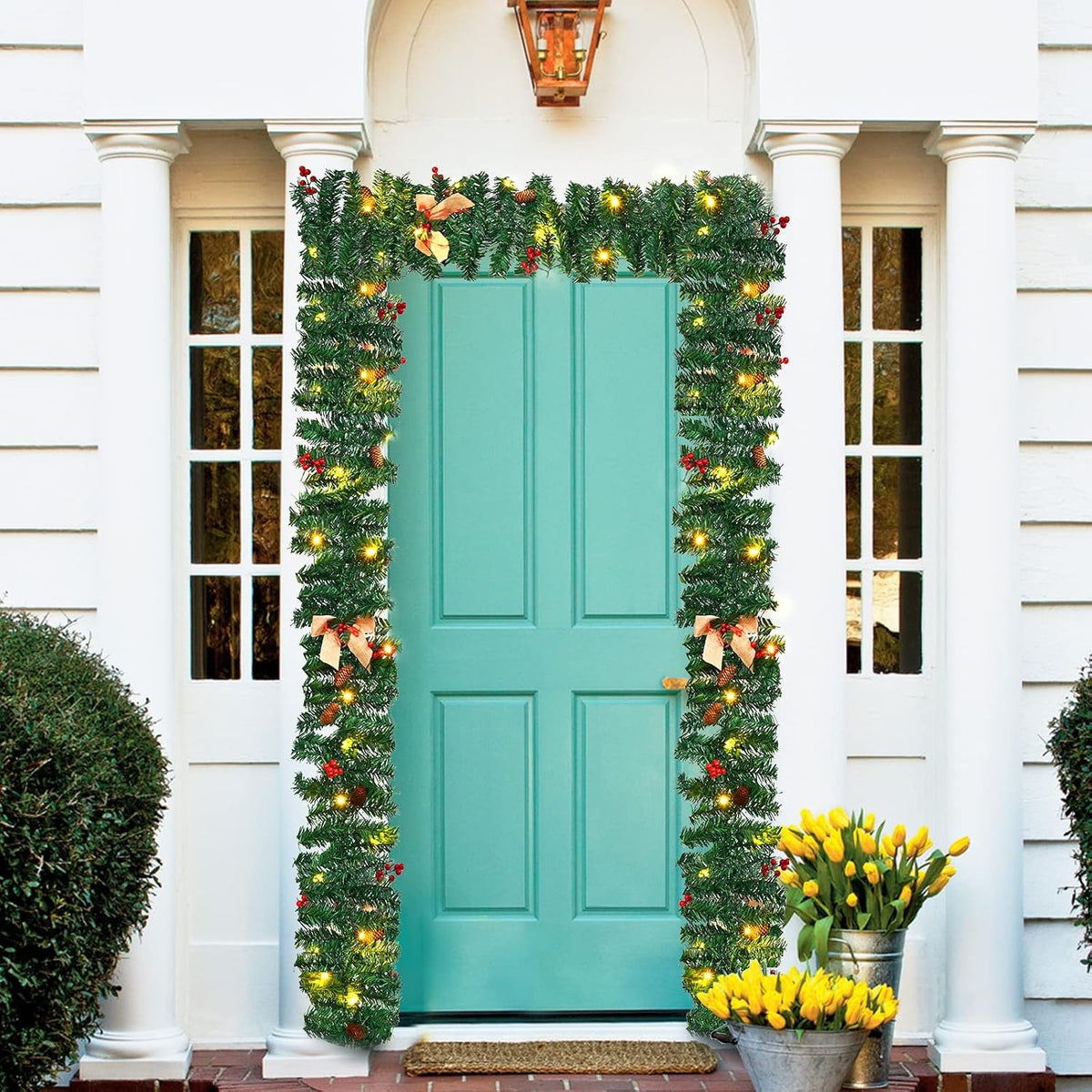 Pre-lit Christmas garland with warm white LEDs framing a teal front door