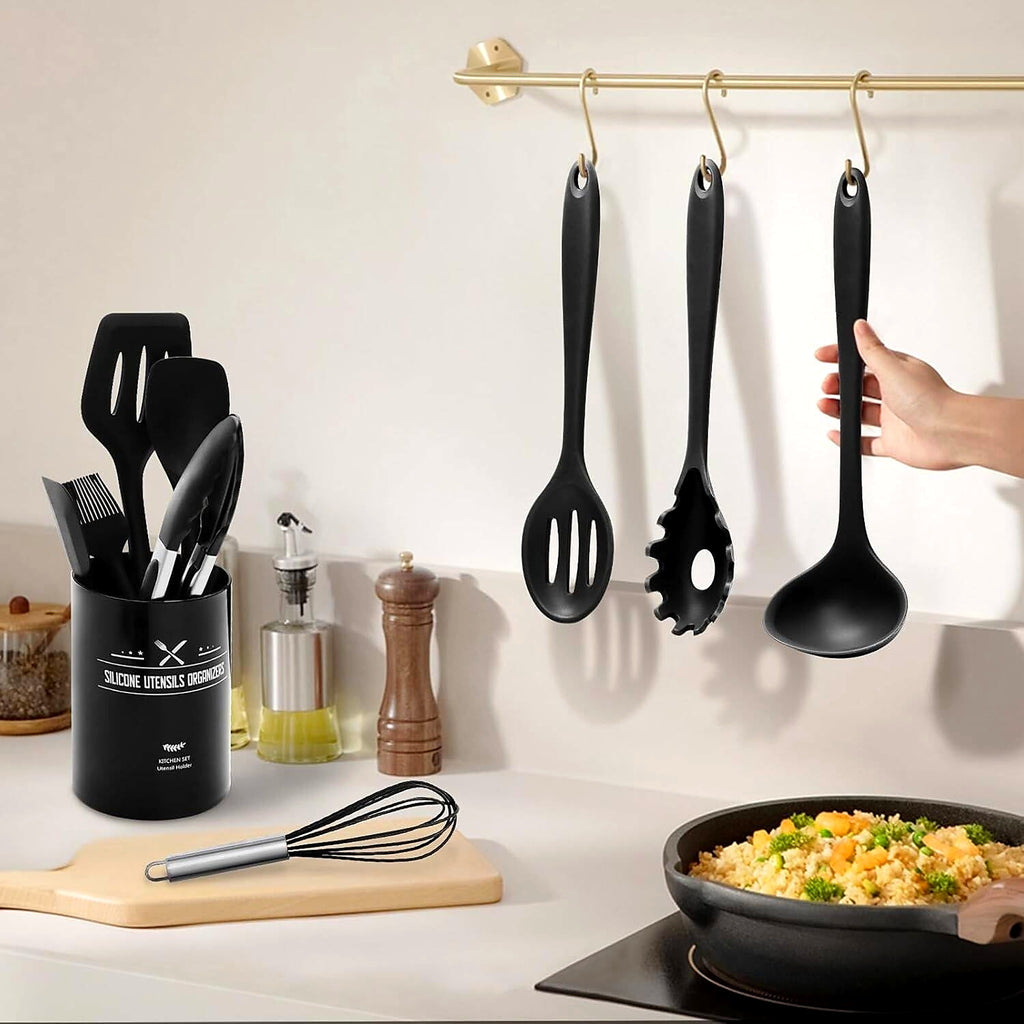 Black silicone utensils hanging and in their holder