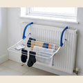 Radiator drying rack with socks and towels on a radiator
