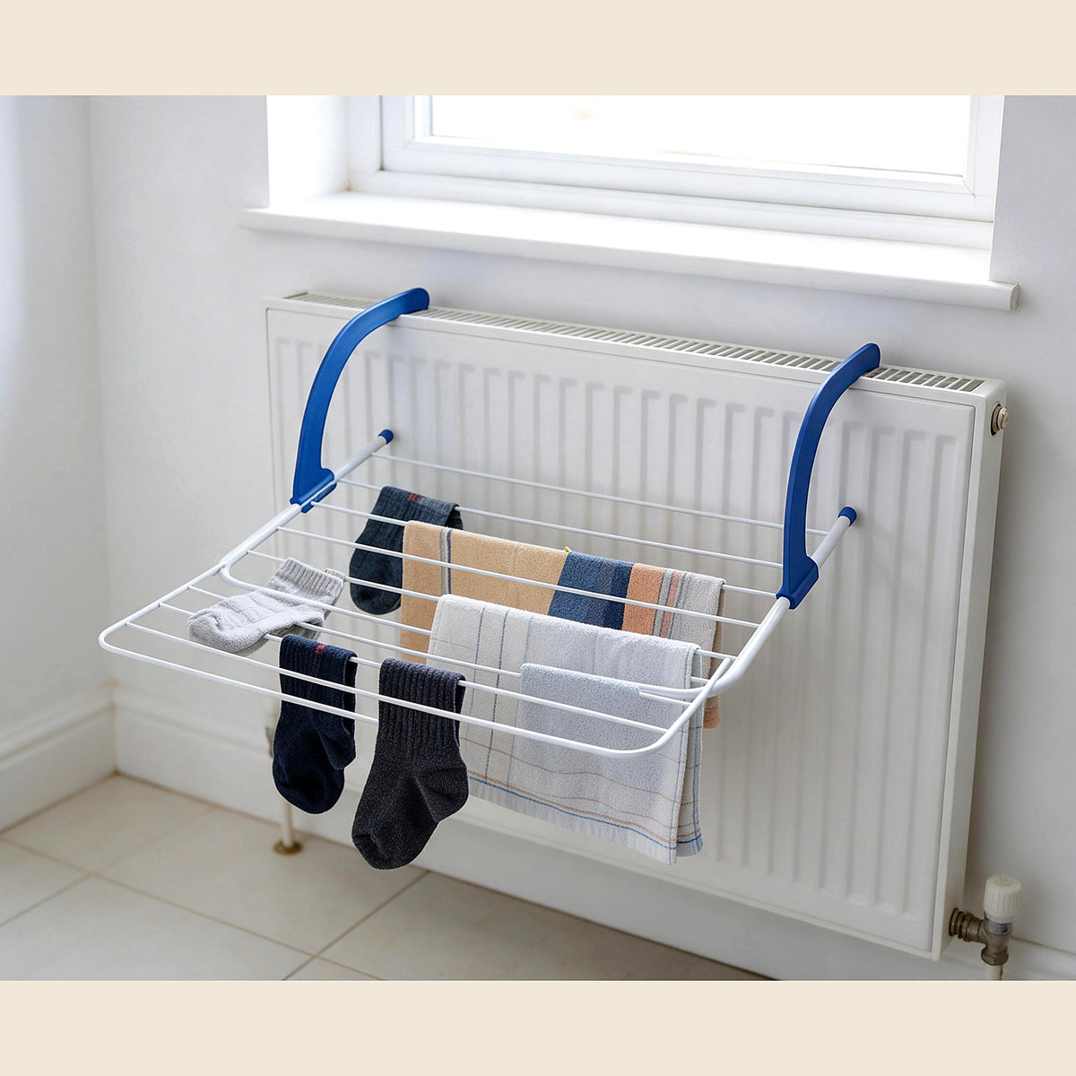 Radiator drying rack with socks and towels on a radiator