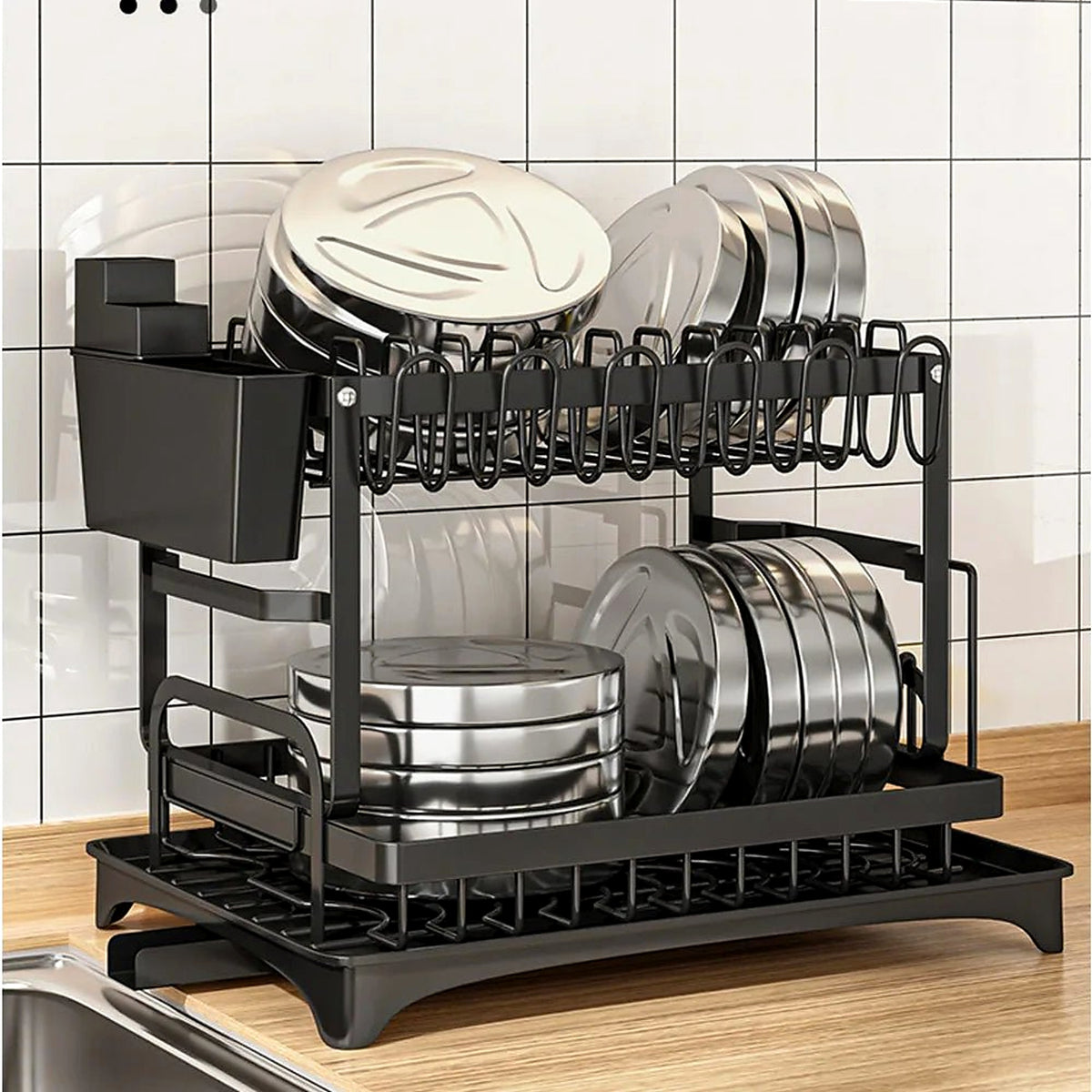 Dish drainer with cups, plates and cutlery on the worktop