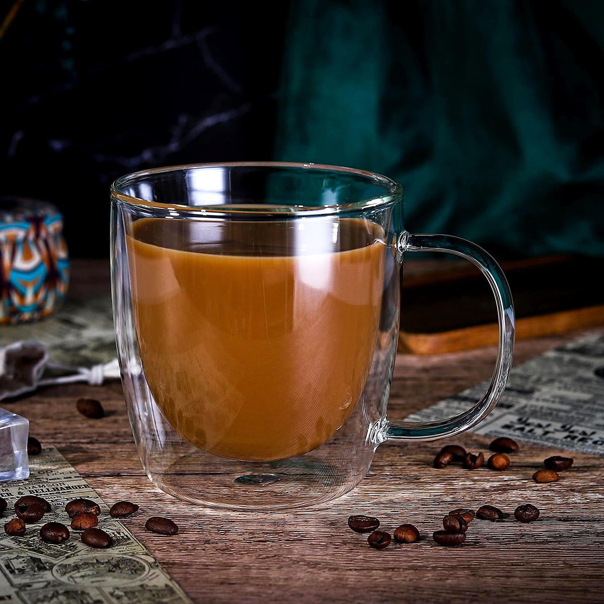 Double-walled glass cup with tea on a wooden table