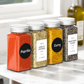 Glass spice jars with shaker lids on a kitchen shelf