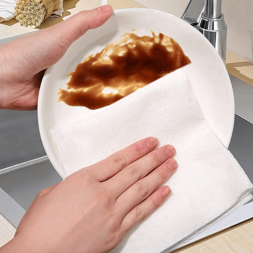 Wiping a plate with a reusable bamboo kitchen towel sheet