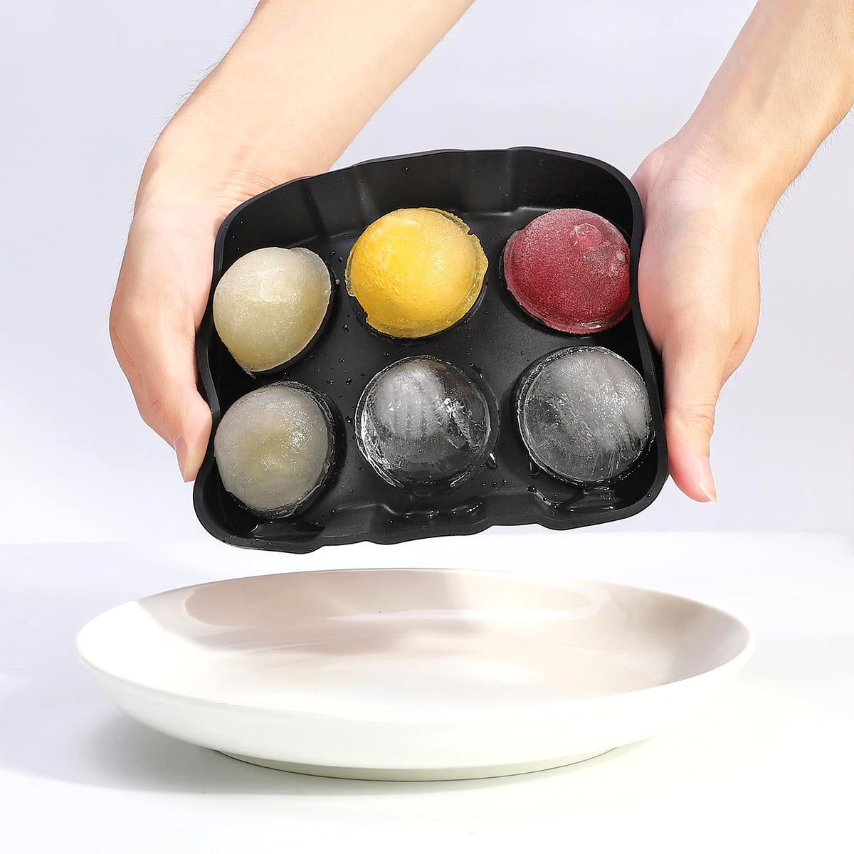 Silicone sphere ice tray in hand
