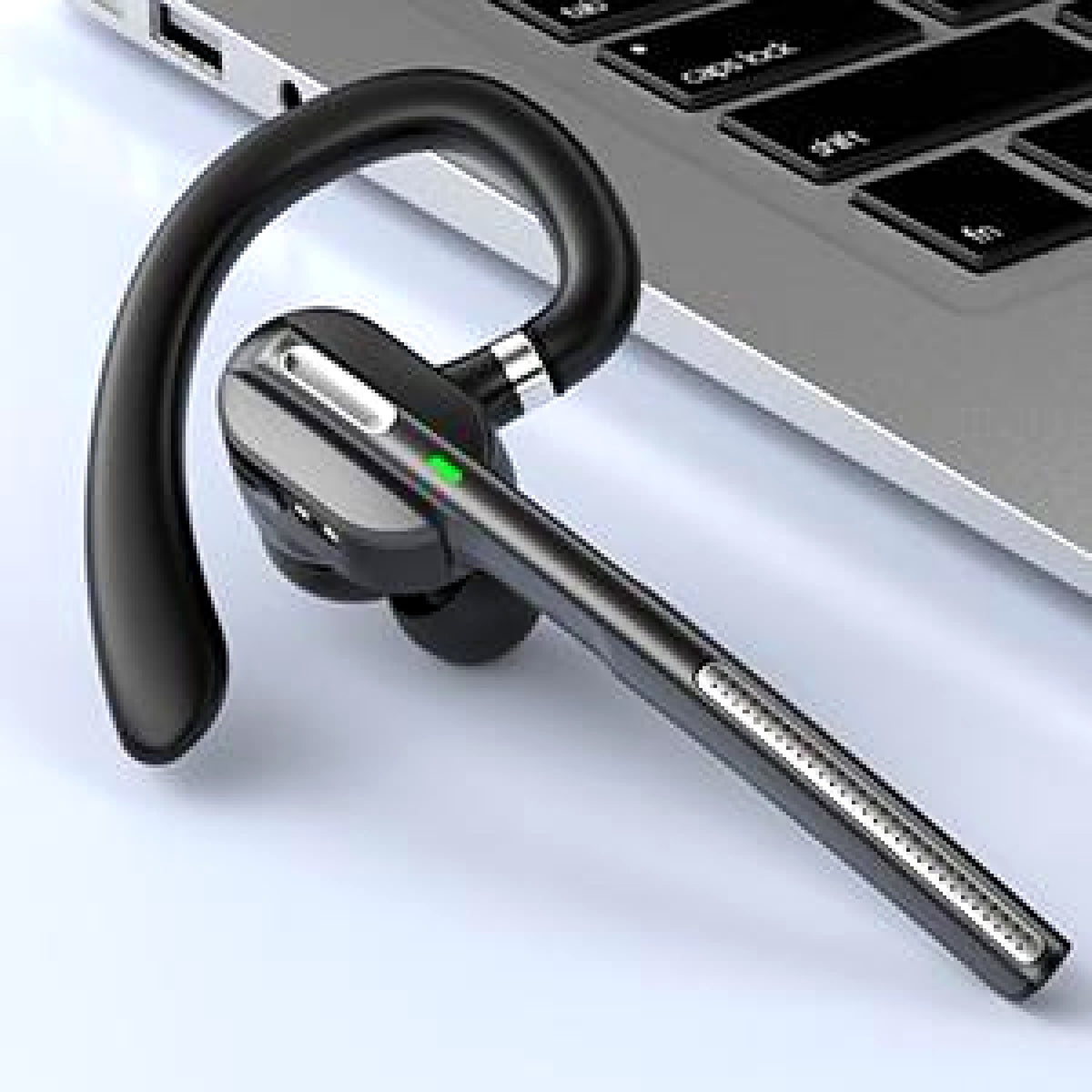 Wireless headset beside a laptop