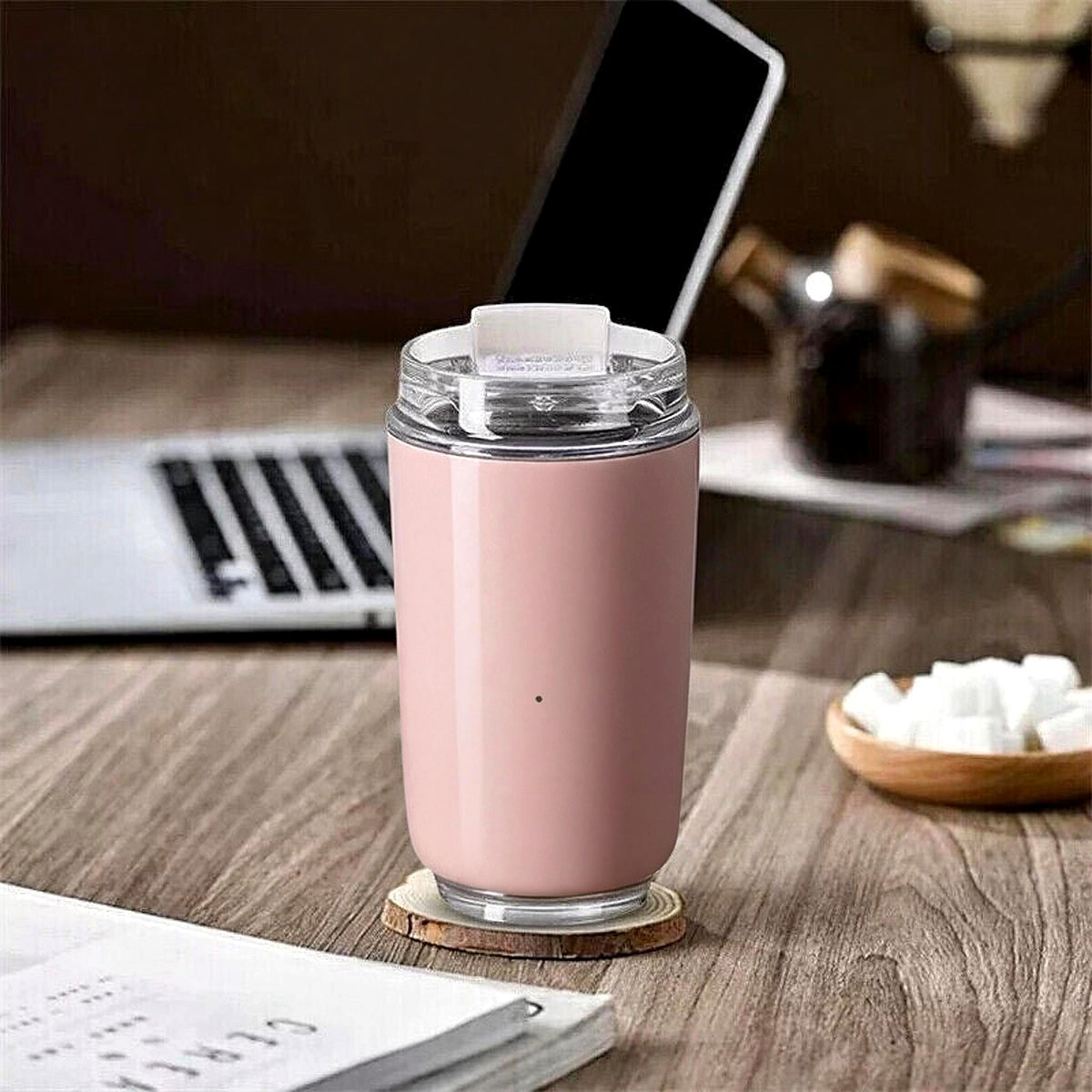 Pink travel mug on a home office desk