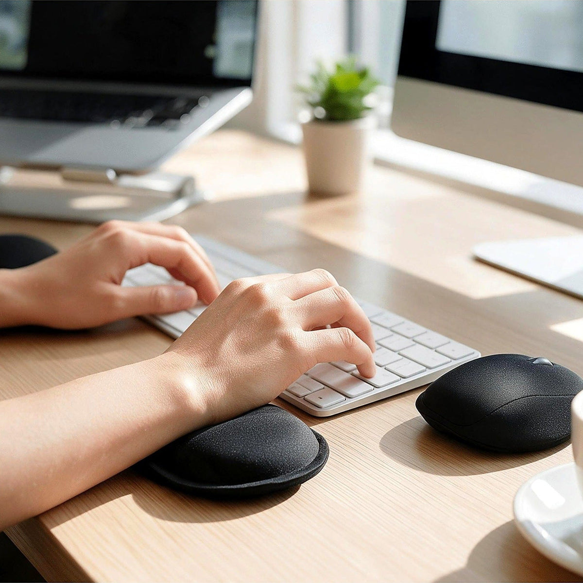 Air wrist pads in use at a tidy home desk